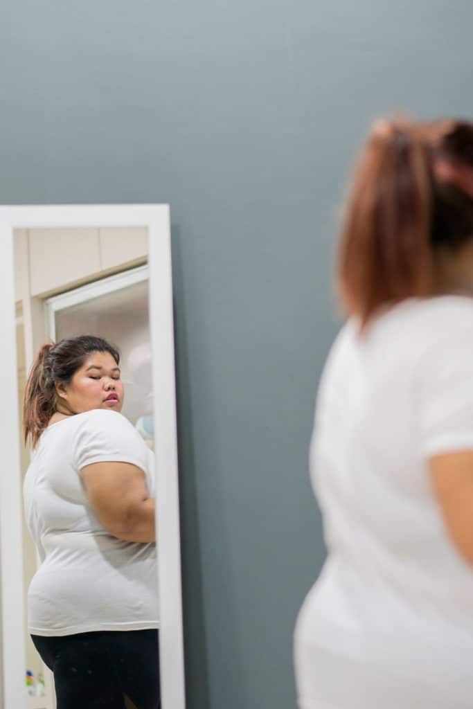 A West Texas Bariatric patient looking at themselves in the mirror